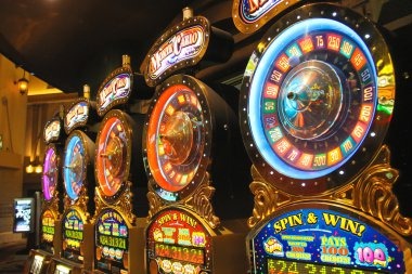 Slot game interface showing stake selection and spin controls